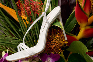 White leather sandal made from sustainable material with tropical flowers