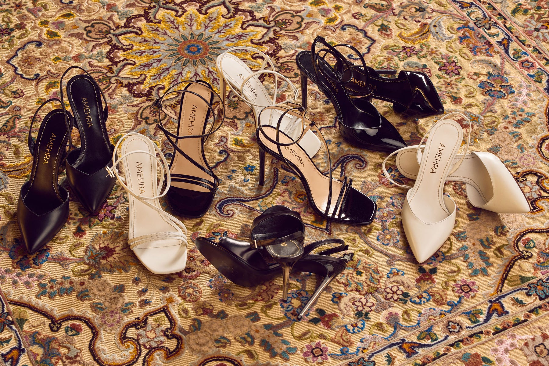 Luxury sustainable women's black and white shoes laid out together on the Persian rug
